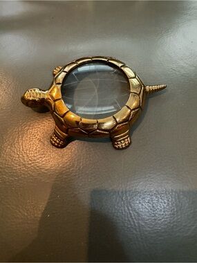 Brass magnifying glass in the shape of a turtle.